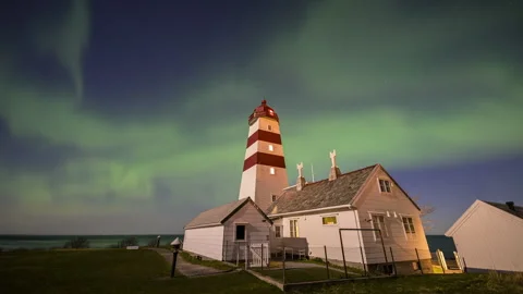 Pulsating Aurora Borealis over lighthouse Stock Footage 250764249