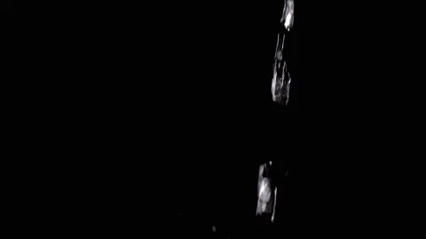 Pulsating Stream of Water, with Splashes, Pours on a Black Background Stock Footage 312013434