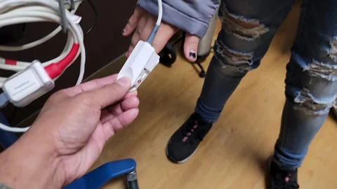 Pulse oximeter applied on pointer finger Stock Footage 253472621