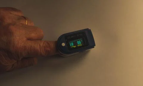 Pulse oximeter on the finger Stock Photos