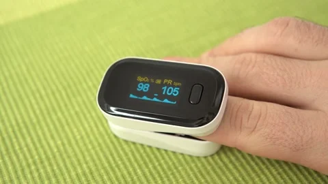 Pulse oximeter measure pulse rate, oxygen saturation level on male finger Stock Footage 142876040