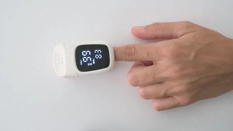Pulse Oximeter Measuring Blood Oxygen Saturation on Patient Finger Stock Footage 342278032
