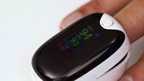 Pulse Oximeter Reading: A close-up shot of a finger inserted in a pulse oxi.. Stock Footage 305084657