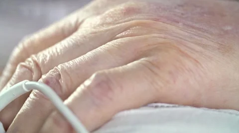 Pulse oximeter sensor at senior patient's finger Stock Footage 58257564