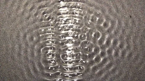 Pulsing standing-waves with modulating amplitude, vertically oriented. Stock Footage 144630989