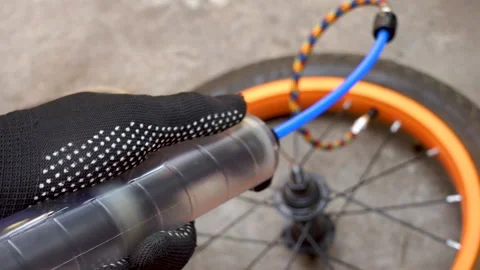 Pump up a bicycle wheel before a walk Stock Footage 204157954