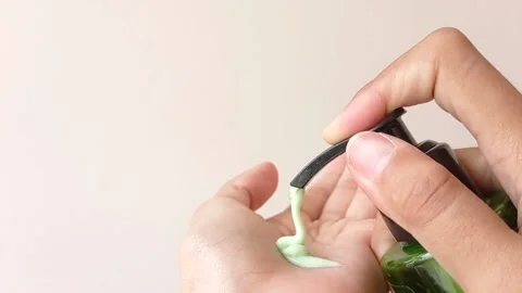 Pump in a hand lotion on its green bottle Stock Footage 145461738