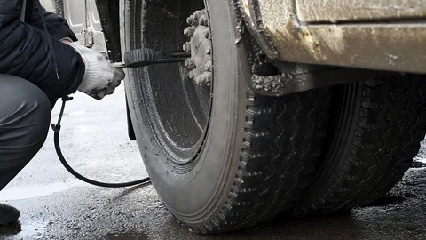 The pump inflates the dirty wheel in the rain in natural light Stock Footage 107089099