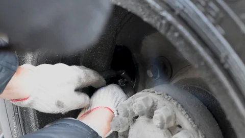 The pump inflates the dirty wheel in the rain in natural light Stock Footage 107089258