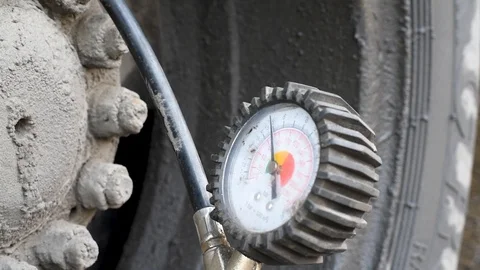 The pump inflates the dirty wheel in the rain in natural light Stock Footage 107307989