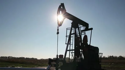 Pump Jack Against the Sun Stock Footage 12510289