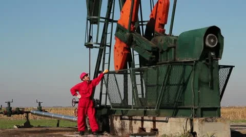 Pump Jack and Oil Worker Stock Footage 12510349