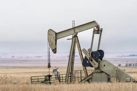 Pump jack in field Stock Photos