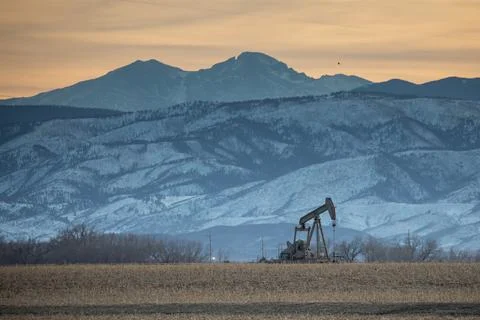 Pump jack with snowy mountains Stock Photos