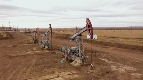 Pump jack in vast oil fields in Russia. Pipelines transporting oil from oil Stock Footage 168922906