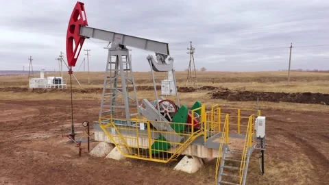 Pump jack in vast oil fields in Russia. Pipelines transporting oil from oil Stock Footage 168922972