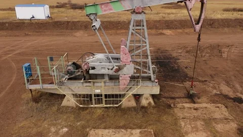 Pump jack in vast oil fields in Russia. Pipelines transporting oil from oil Stock Footage 169073806
