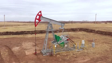 Pump jack in vast oil fields in Russia. Pipelines transporting oil from oil Stock Footage 170332124