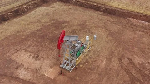 Pump jack in vast oil fields in Russia. Pipelines transporting oil from oil Stock-Footage 170508709