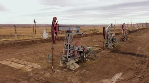 Pump jack in vast oil fields in Russia. Pipelines transporting oil from oil Stock Footage 170669268