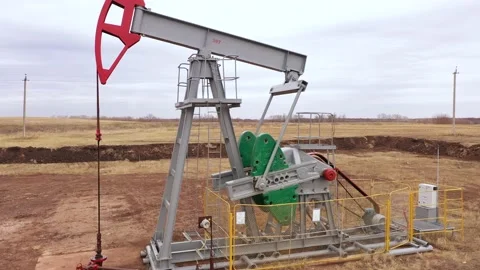 Pump jack in vast oil fields in Russia. Pipelines transporting oil from oil Stock Footage 172054639