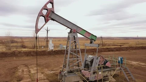 Pump jack in vast oil fields in Russia. Pipelines transporting oil from oil Video stock 172538260