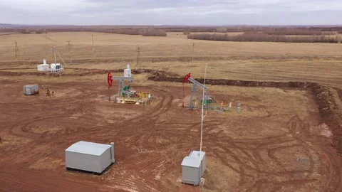Pump jack in vast oil fields in Russia. Pipelines transporting oil from oil Stock Footage 174869360