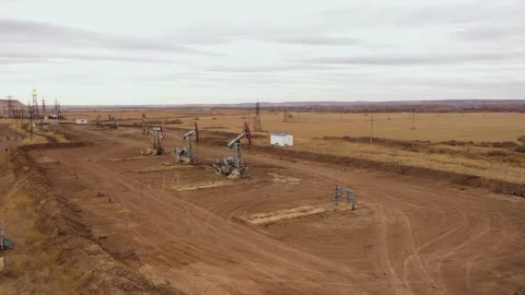 Pump jack in vast oil fields in Russia. Pipelines transporting oil from oil Video stock 175650907