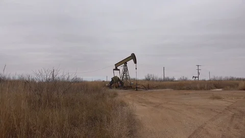 Pump jack working In the oil field. Stock Footage 85711562