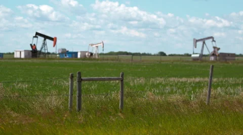Pump jacks side by side in the prairies. Stock Footage 67612536