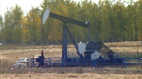 Pump jacks working in a field for oil and gas industry. Stock Footage 59843118