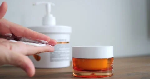 Pump pressing on bottle to release moisturizing cream, cream dispensing Stock Footage 311750434