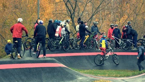 Pump track. Different ages of Extreme cyclists in special tricks area Stock Footage 97294769
