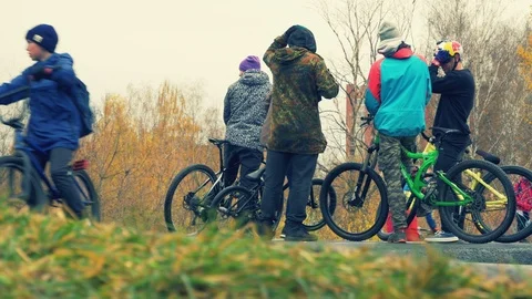 PUMP TRACK. Different ages of Extreme cyclists in special tricks area Stock Footage 97295398