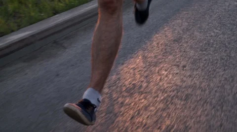 Pumped up athlete's foot close-up while Jogging 库存影片 64496737