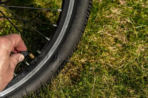 Pumping up a bicycle with a pump, flat tire, repairing a flat inner tube in.. Stock Photos