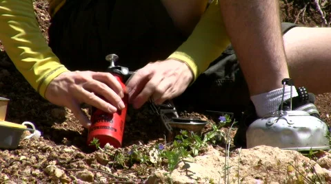 Pumping the camping stove.  Stock Footage 751225