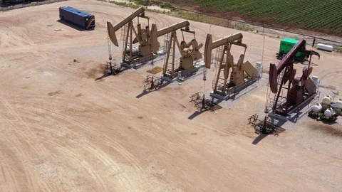 Pumping oil with 4 pumpjacks, Brazos County, Texas, USA Stock Footage 129218385