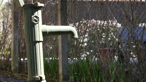 Pumping old water pump to get some water Stock Footage 88784465