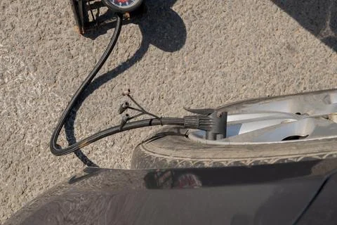 Pumping up one flat car tire with foot Stock Photos