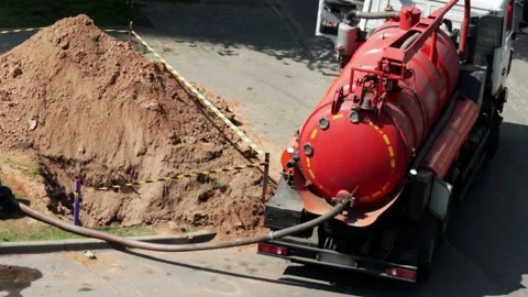Pumping tank against the background of a pit with a fence. Concept of Stockbeeldmateriaal 317808272