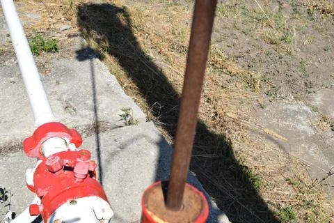The pumping unit as the oil pump installed on a well Stock Photos