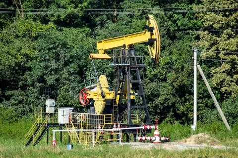 Pumping unit as the oil pump installed on a well Stock Photos