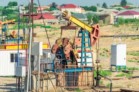 Pumping unit as the oil pump installed on a well. Equipment of oil fields Aze Stock Photos