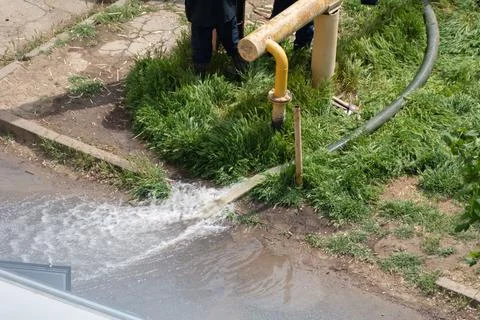 Pumping water out of the pit when eliminating an sewer accident, rupture of p Stock Photos