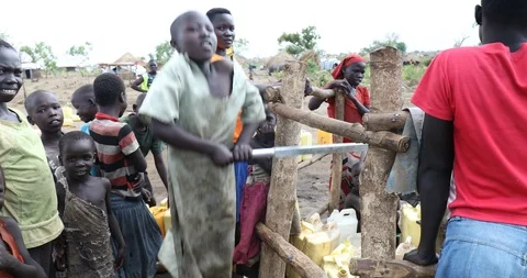 Pumping Water at a Refugee Settlement Stock Footage 93914315