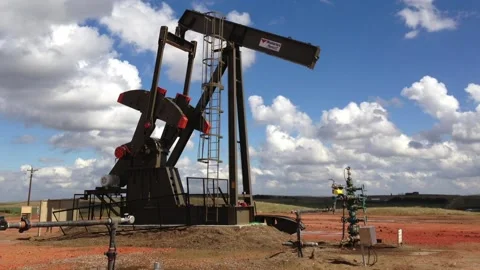 Pumpjack disabled - slow zoom to wellhead valves (cross) Stock Footage 146133952