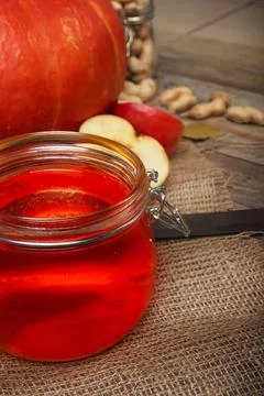 Pumpkin and apple pie with a jar of jam on a wooden table Stock Photos