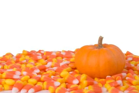 Pumpkin and candy corn Stock Photos