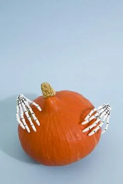 Pumpkin and hands Stock Photos